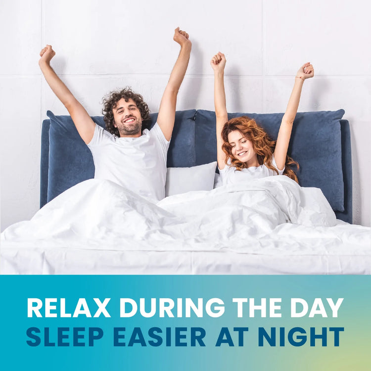 A man and woman sit up in bed smiling under a white blanket. Text at the bottom reads, RELAX DURING THE DAY, SLEEP EASIER AT NIGHT—with Senzu Health L-Theanine 250mg vegan capsules for daily relaxation.